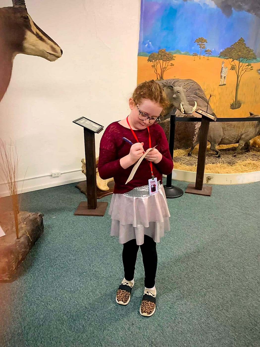 A young visitor working her scavenger-hunt sheet